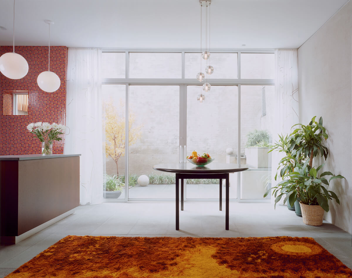Carroll Gardens Row House with glass wall to garden